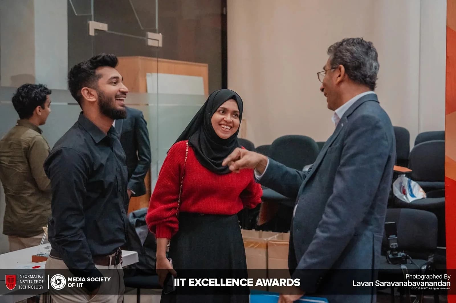 IIT Excellence Awards: two team members speaking with an event attendee